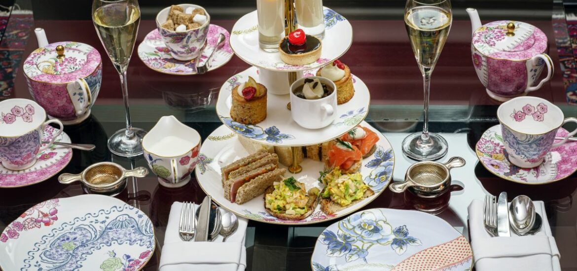 porcelain dishes with tea champagne and canapes