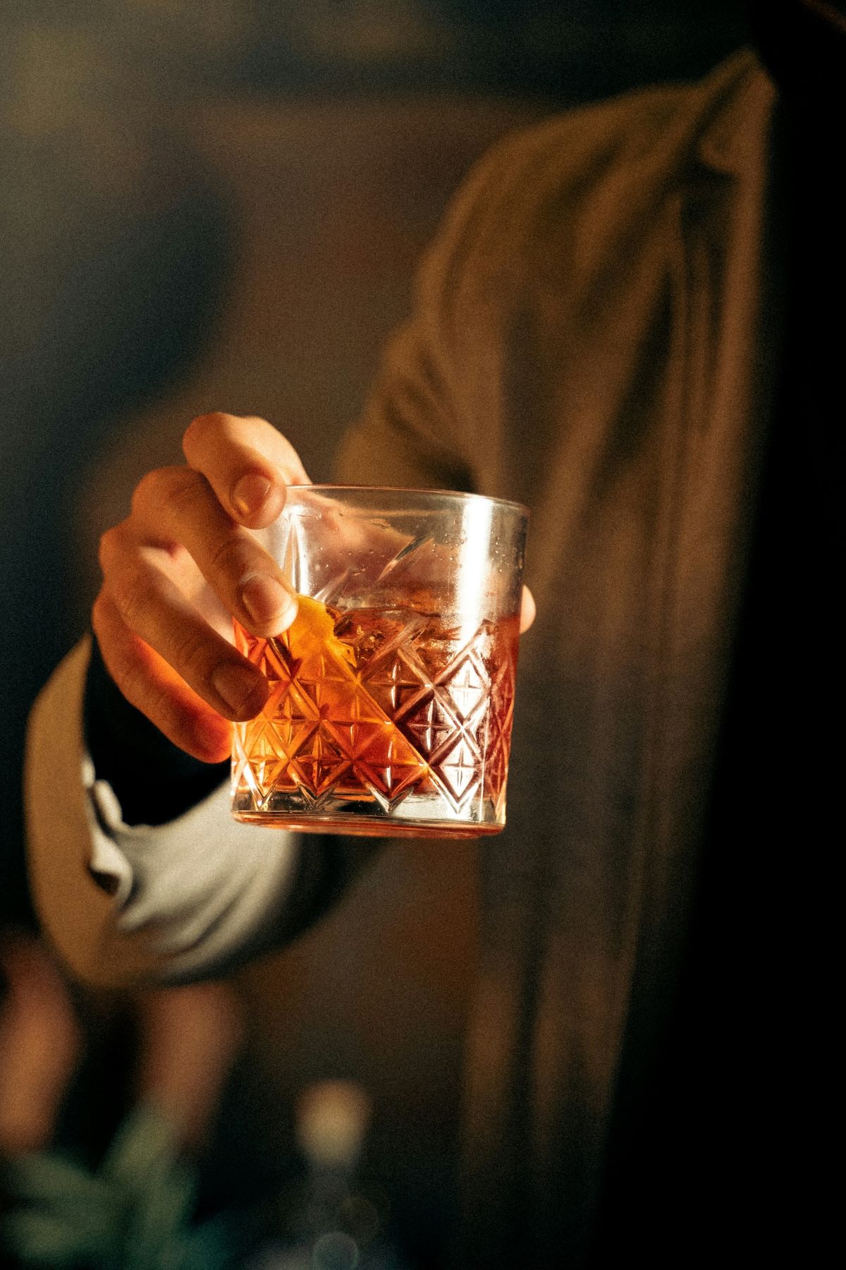 A man holding an old fashioned at Bordeaux speakeasies.