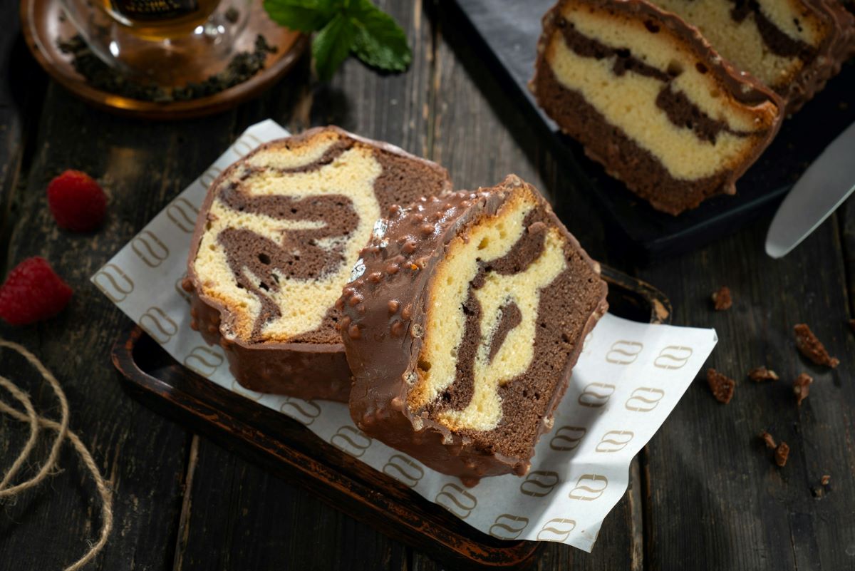 Two slices of marbled cake slices on top on parchment paper. 