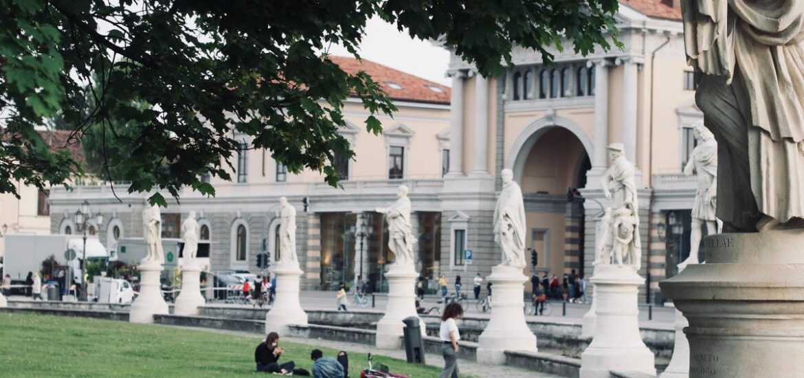 square with green grass and old beautiful buildings