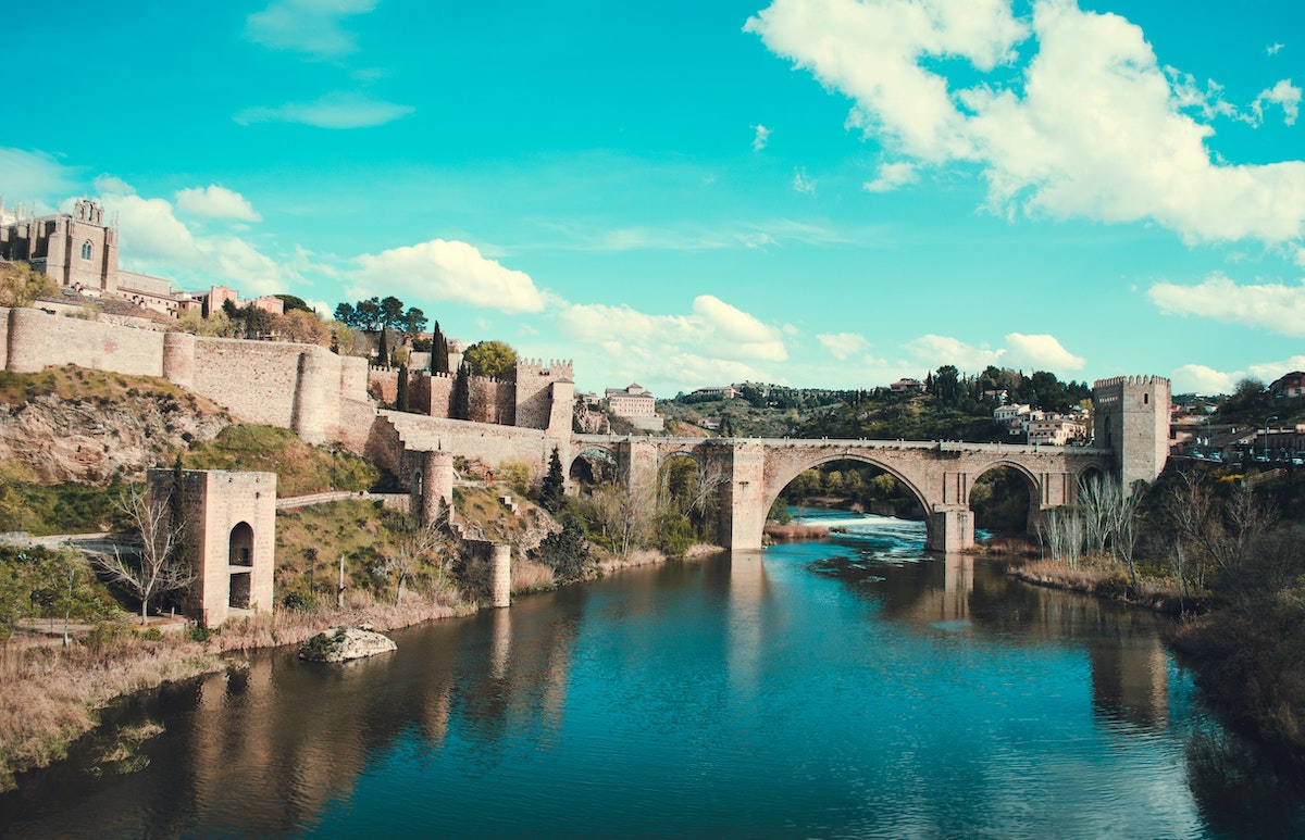 Arched stone bridge over a river