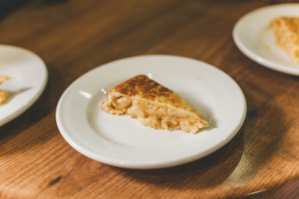 Tortilla de patatas is one of the classic Spanish dishes available on our vegetarian food tours in Madrid.