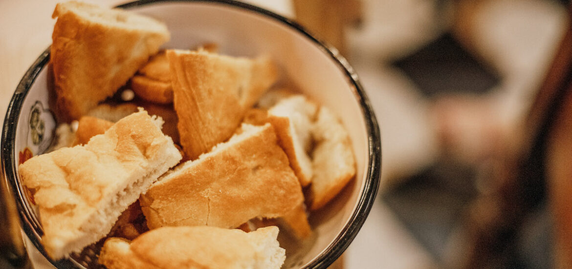 Tuscan bread sliced into thick chunks and served in a ceramic bowl