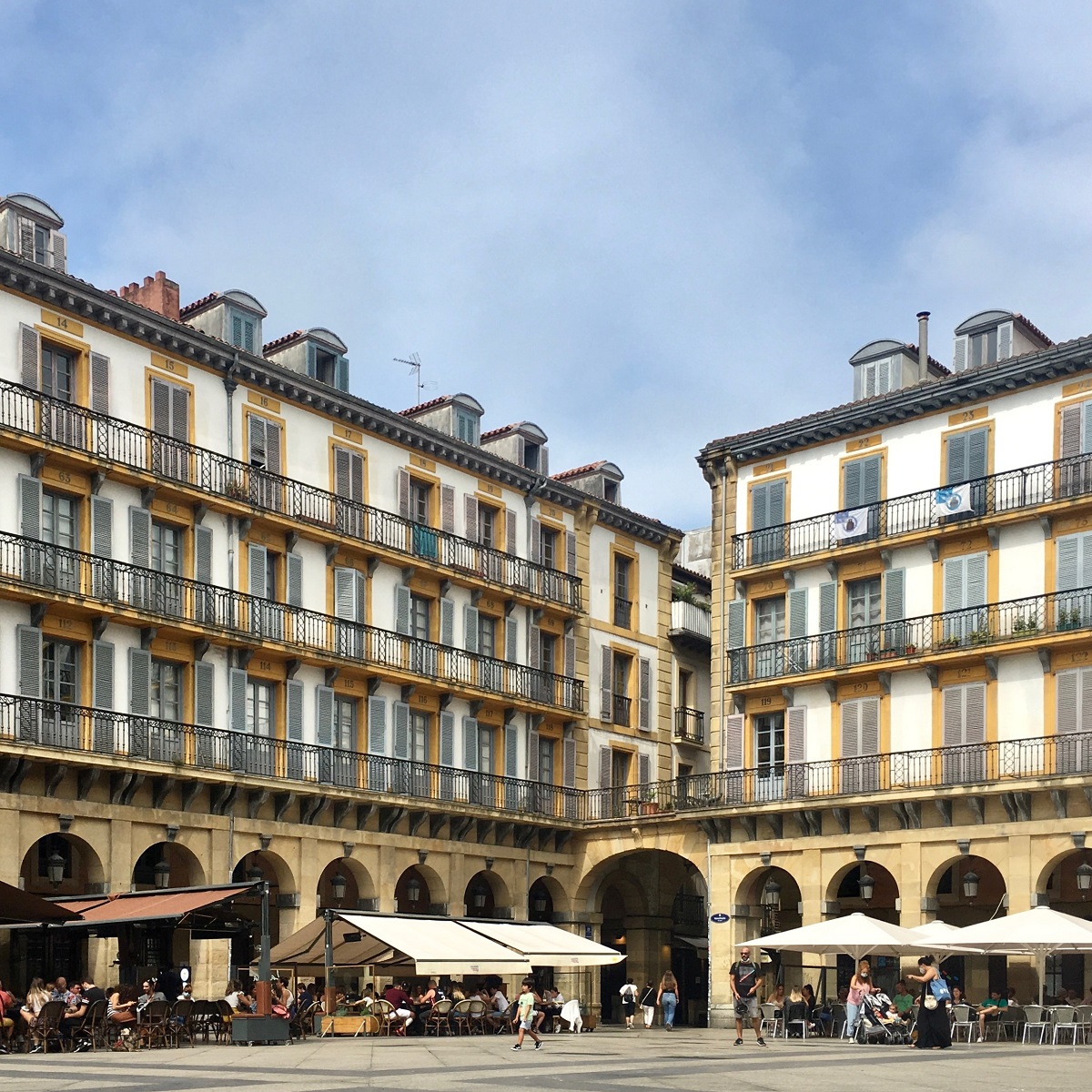 San Sebastian's old town with columns, umbrellas, and outdoor bars