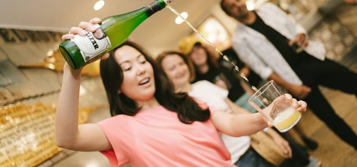 Woman pouring cider into a glass