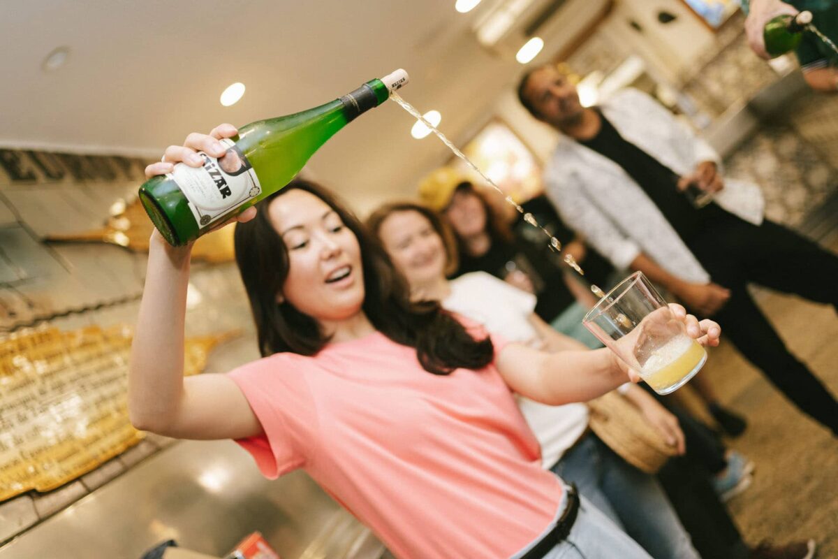 Woman pouring cider into a glass