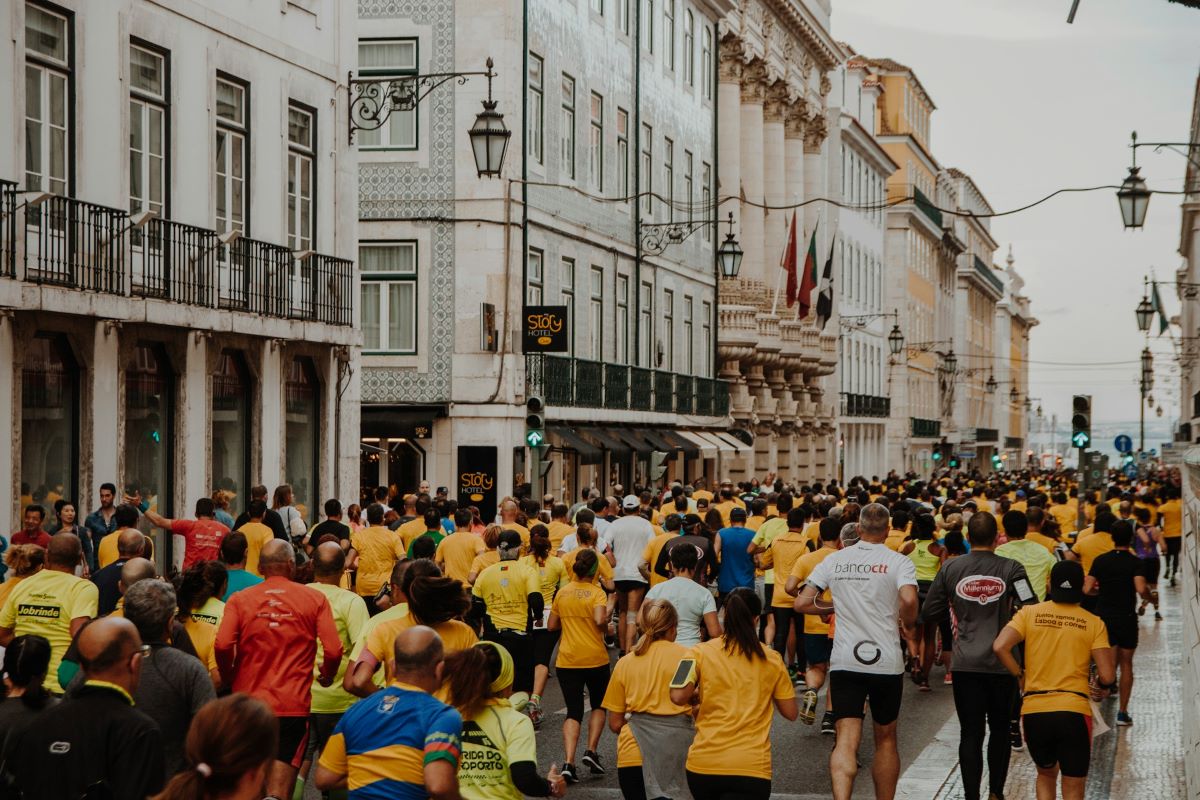 People running down the streets of Lisbon at the Lisbon Marathon. 